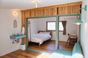 沼津palette的一间卧室配有床、水槽和镜子