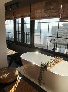 雅西Great Exodus - Iasi City Center的带浴缸的浴室和大窗户