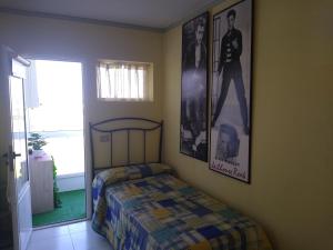 福斯Apartamento en Foz Entreplayas的卧室配有一张床,墙上挂有图片