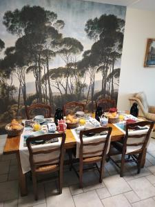 圣波勒-德莱昂Chambres d'Hôtes "Les Hauts Vents"的用餐室配有餐桌和食物