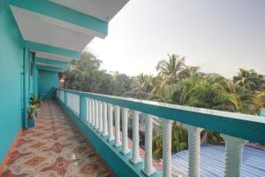 巴加Comfort Holiday Home的阳台享有大海和棕榈树的景致。