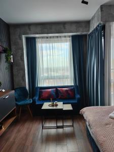 普罗夫迪夫Luxury Apartment/Studio的一间卧室设有蓝色的沙发和窗户。