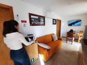 恩特雷里奥斯Burguesinha AL Entre-os-Rios的站在客厅里玩电子游戏的女人