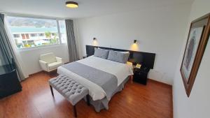 伊瓦拉Hotel Ajavi的卧室配有床、椅子和窗户。