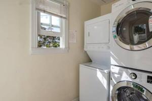 基韦斯特Coral Cove #1 by Brightwild的洗衣房配有洗衣机和窗户