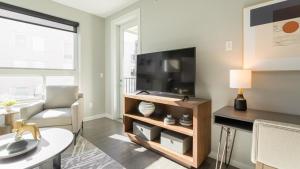 纽波特Landing Modern Apartment with Amazing Amenities (ID8359X76)的客厅配有台面上的平面电视