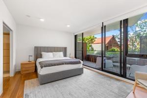 墨尔本Fantastic 3-Bed Home by Melbourne Uni & Zoo的一间卧室设有一张床和一个大窗户