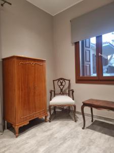 希俄斯Castle luxury home的一间带椅子、橱柜和窗户的房间
