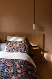DannesMoulin Moulin Maison d'Hôtes的一间卧室配有带枕头和床头柜的床