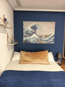 厄尔·阿尔特Alicante airport and beach的一间卧室,拥有一幅蓝色的墙壁和一幅波浪画