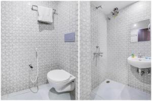 班加罗尔FabHotel KSP Kings Inn的带淋浴、卫生间和盥洗盆的浴室