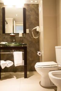 蒙得维的亚厄尔巴诺丽晶高尔夫酒店的一间带卫生间、水槽和镜子的浴室