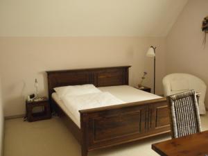 Feldkirchen bei Graz赫博特斯塔本酒店的一间卧室配有一张床、一把椅子和一张桌子