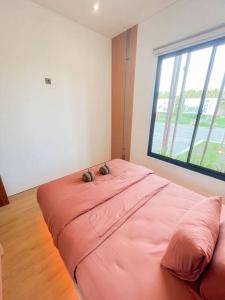 斯勒曼Villa Kamar Tamu Balecatur 2的窗户客房内的一张粉红色大床