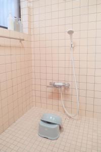 四万十市四万十川傍にある日本家屋まるごと「貸切宿　ほとり」的浴室设有蓝色卫生间和软管