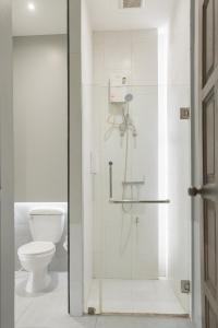 清迈清迈鸦片公寓式酒店的浴室设有玻璃淋浴间和卫生间