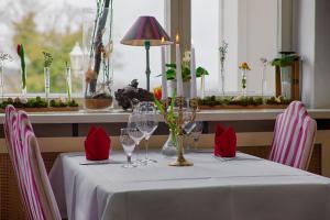 黑灵斯多夫Hotel Weißes Schloß的一张桌子,上面放着红餐巾和酒杯