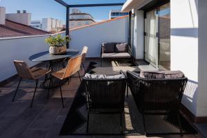 蒙特加特Atico duplex Playa Area barcelona con SPA exterior的阳台的天井配有桌椅