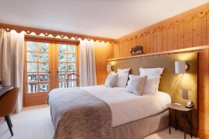 梅杰夫La Ferme du Golf的卧室设有一张白色大床和一扇窗户。