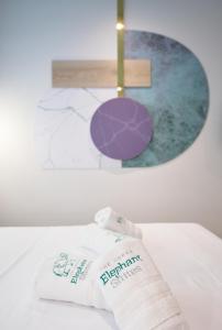 塞萨洛尼基Urban Elephant Suites的床上的毛巾,带绘画