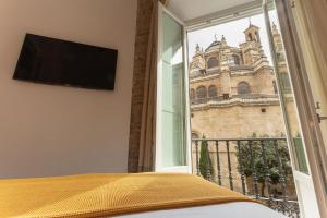 格拉纳达Casa Miravalle Catedral的一间卧室设有窗户,享有教堂的景色
