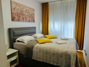 萨格勒布Nova Galerija Studio Vita i Apartman Sara的一间卧室配有一张带黄色枕头的大床