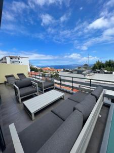 丰沙尔Apartamento Belo Horizonte的阳台配有沙发,享有海景