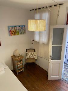 布宜诺斯艾利斯La casona de Palermo Hostel Boutique的一间卧室配有一张床、一把椅子和一个吊灯。