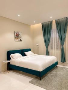 艾卜哈نزل الراشد الفاخرة luxury的一间卧室设有蓝色的床和窗户。