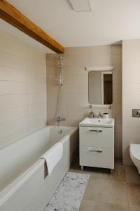 蒂米什瓦拉Holiday Agoston Apartments的白色的浴室设有浴缸和水槽。