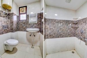 新德里FabExpress Abode Inn的浴室配有卫生间、浴缸和水槽。
