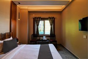 KhandagiriOYO Flagship Welcome Premium的卧室配有一张床和一张桌子及椅子