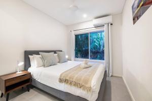 达尔文'Infinity's Edge' Darwin Luxury Waterfront Oasis的一间卧室设有一张大床和一个窗户。