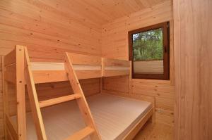 梅尔诺Bajkowy Las的小木屋设有双层床和窗户。