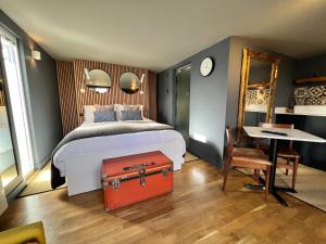 塔维斯托克Rockmount Rooms & Apartment的一间卧室配有一张带红色手提箱的床
