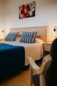 圣阿古斯丁卡塔利亚公寓的一间卧室配有一张床、一张桌子和一朵红花