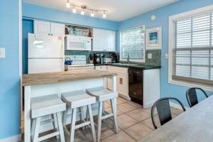 基韦斯特Bermuda Suite by Brightwild的厨房拥有蓝色的墙壁,配有桌椅