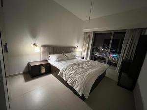 阿布扎比Dinar Home的一间卧室设有一张大床和一个窗户。