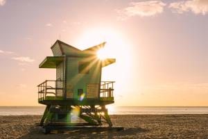 迈阿密海滩Sonder The Abbey的海滩上一座救生塔,背着太阳