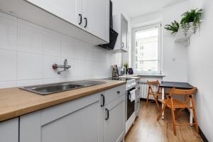 格丁尼亚Prime Home CENTRUM 2的白色的厨房设有水槽和台面