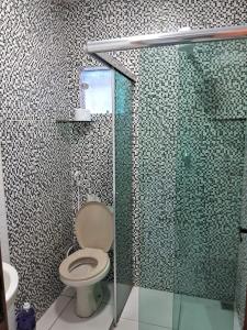 马瑙斯Edward Suíte Manaus 03的一间带卫生间和玻璃淋浴间的浴室