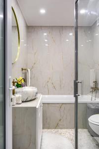 阿拉德Sika Luxury Apartment的带淋浴、盥洗盆和卫生间的浴室