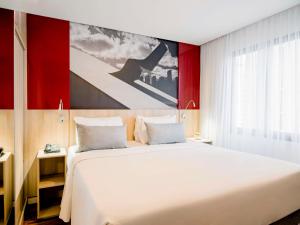 圣保罗圣保罗莫埃玛时代广场美居酒店的卧室配有一张白色大床和一幅画