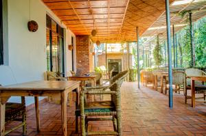 鲁亨盖里Susa Gardens的户外庭院配有桌椅和桌子。