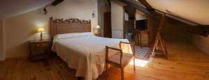 拉斯赫勒里亚斯Paraiso del Bierzo的一间卧室设有一张大床,铺有木地板