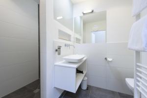 吕讷堡einzigartig - Das kleine Hotel im Wasserviertel的白色的浴室设有水槽和镜子