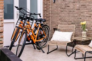 赞德沃特Casa la Vida Beach House的停放在砖墙旁边的橘子自行车