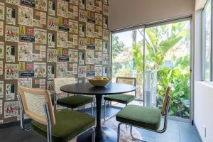 洛杉矶Stunning Hollywood Midcentury Modern-Views-Best Location!的一张桌子和椅子,位于一个贴有海报的房间里