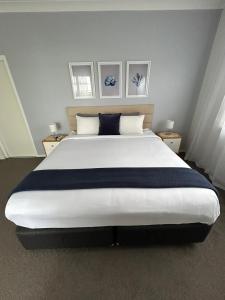黄金海岸Mermaid - Magic king unit的卧室内的一张大床,带两个床头柜