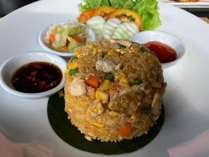 暹粒Le Vert Angkor Hotel的饭,蔬菜和酱料的盘子